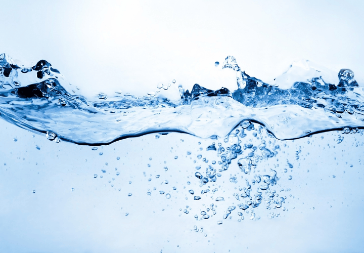 clean water pouring into glass representing cellular hydration and water quality