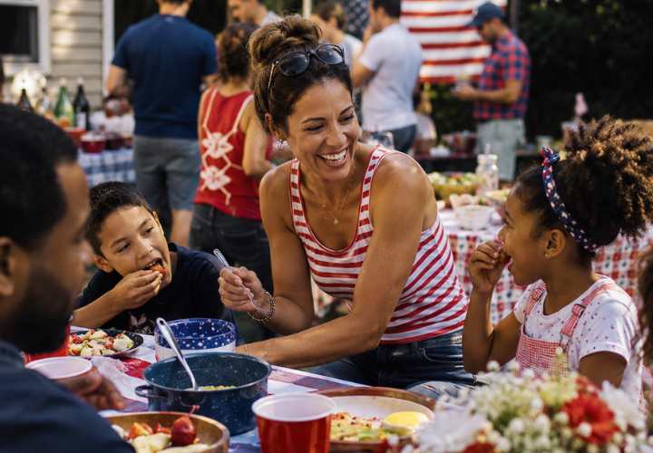Family enjoying a healthy July 4th cookout with fresh food and outdoor holiday celebration