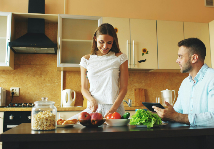 Young couple preparing healthy food together as part of a preconception lifestyle