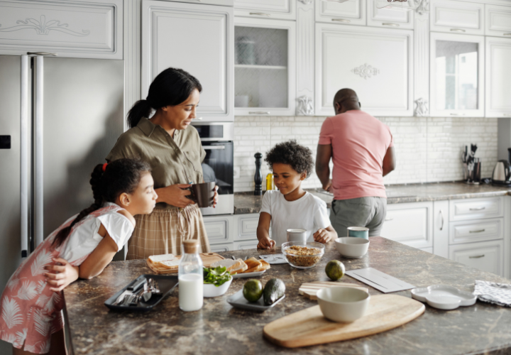 Family preparing breakfast together in the kitchen as part of a healthy daily routine
