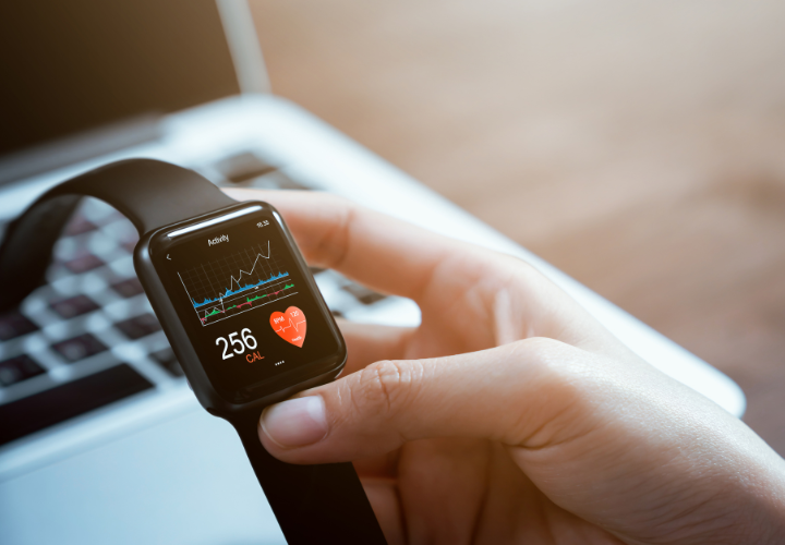 Person checking health and activity data on a smartwatch